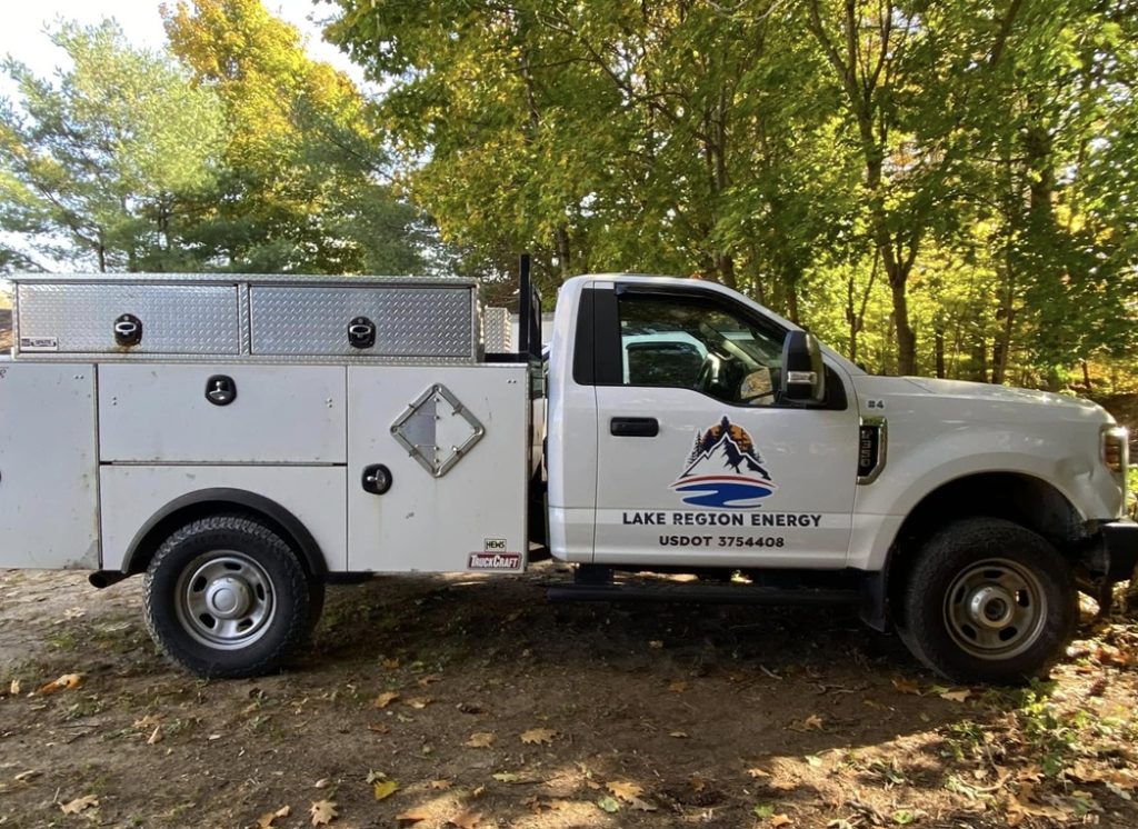 White truck with "lake region energy" truck lettering